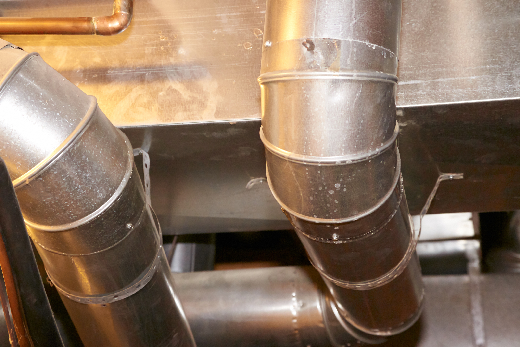 Intricate metal ductwork highlights the complex systems that skilled HVAC professionals maintain for optimal performance and safety.